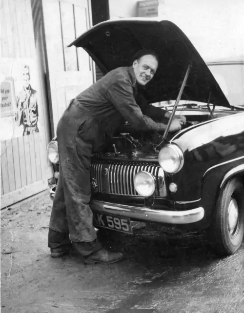 Don Kennedy under the bonnet of a 1954 Ford Consul.